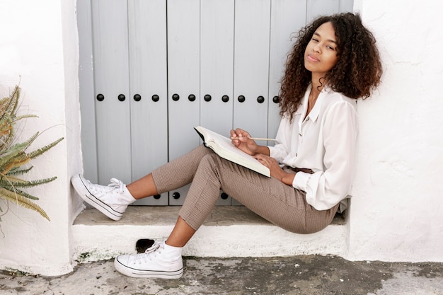 Steal Lori Harvey's Style: Rock Her $275 YSL Cap, $1,000 The Attico Cargo Pants, and $2,350 Bottega Veneta Pouch in Los Angeles